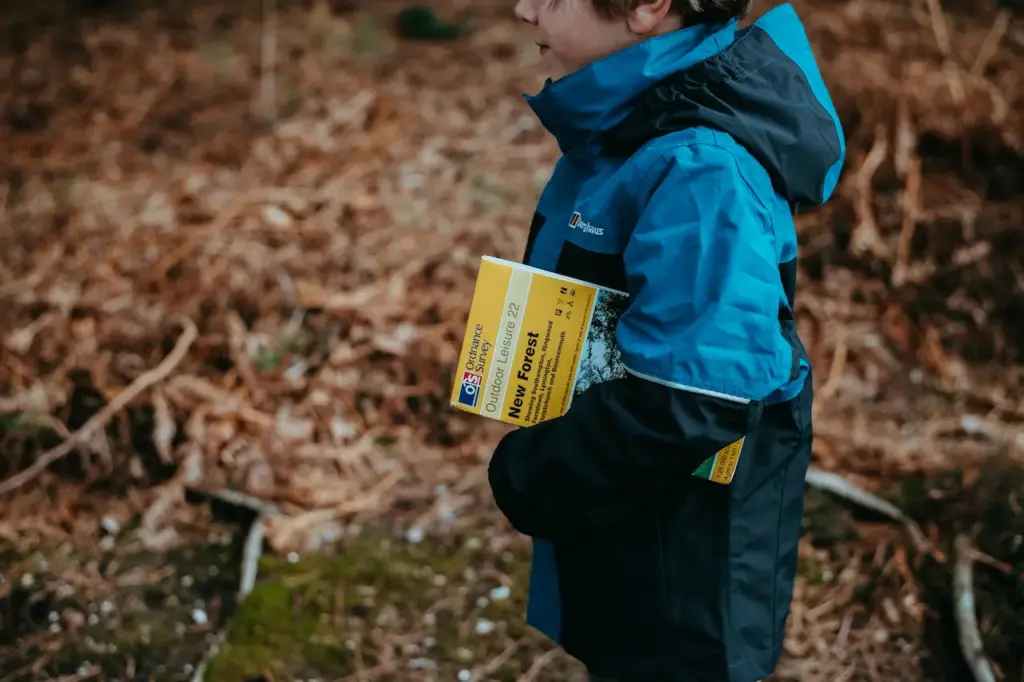 Kid Holding the Guide for New Forest 
