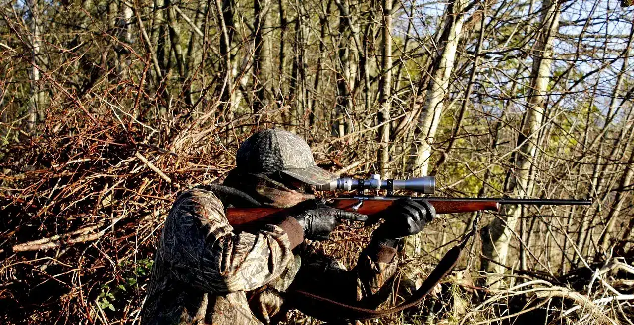 Shooter Taking Aim In The Bush